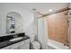 Small, vintage bathroom with arched mirror, black granite countertop, and shower/tub at 62 High Top Pt, Sandy Springs, GA 30328