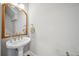 Classic bathroom featuring a pedestal sink, elegant mirror, and neutral decor at 62 High Top Pt, Sandy Springs, GA 30328