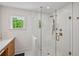 Glass shower with bronze fixtures and white tile in updated primary bathroom at 62 High Top Pt, Sandy Springs, GA 30328