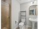 Well-lit bathroom featuring a glass-enclosed shower, pedestal sink, and neutral color palette at 62 High Top Pt, Sandy Springs, GA 30328