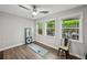 Bonus room featuring wood floors, natural light, and workout equipment at 62 High Top Pt, Sandy Springs, GA 30328