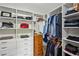 Walk-in closet features custom shelving, drawers, and hanging space for organized storage at 62 High Top Pt, Sandy Springs, GA 30328
