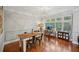 Stylish dining area with a rustic table, large windows, and hardwood floors at 62 High Top Pt, Sandy Springs, GA 30328