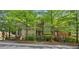 Attractive townhome with brick and siding, mature trees, and well-maintained front yard at 62 High Top Pt, Sandy Springs, GA 30328