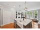 Open concept kitchen island with sink, pendant lighting, and bar seating area at 62 High Top Pt, Sandy Springs, GA 30328