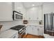 Modern kitchen features white cabinets, stainless steel appliances, and a gas cooktop stove at 62 High Top Pt, Sandy Springs, GA 30328