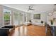 Cozy living room with hardwood floors, a modern ceiling fan, and bright windows with natural light at 62 High Top Pt, Sandy Springs, GA 30328