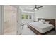 Bright main bedroom features a tray ceiling, ceiling fan, and ensuite bath with glass shower at 62 High Top Pt, Sandy Springs, GA 30328