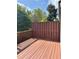 Outdoor deck with a brown fence, wood flooring and string lights at 702 Emeril Dr, Avondale Estates, GA 30002