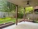Covered patio overlooking a well-maintained backyard with flower beds and mature trees at 702 Emeril Dr, Avondale Estates, GA 30002