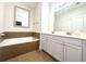 Luxurious bathroom with a soaking tub, dual vanities, and modern fixtures at 702 Emeril Dr, Avondale Estates, GA 30002