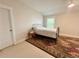 Cozy bedroom features a comfortable bed, decorative rug, and natural light from the window at 702 Emeril Dr, Avondale Estates, GA 30002