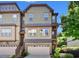 Three story townhouse with attached garage and neutral colored siding at 702 Emeril Dr, Avondale Estates, GA 30002