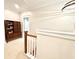Bright hallway with wood railing and view of built in shelves at 702 Emeril Dr, Avondale Estates, GA 30002