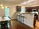 Open kitchen with hardwood floors, modern appliances, and breakfast bar at 702 Emeril Dr, Avondale Estates, GA 30002