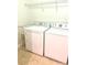 Bright laundry area with modern washer and dryer, and wire shelving for storage at 702 Emeril Dr, Avondale Estates, GA 30002