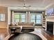 Cozy living room featuring a fireplace, large windows, and stylish furnishings at 702 Emeril Dr, Avondale Estates, GA 30002