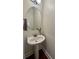 Elegant powder room with pedestal sink and decorative mirror at 702 Emeril Dr, Avondale Estates, GA 30002