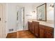 Bathroom with a light-toned countertop, wooden cabinets, and a door that opens into the attached bathroom at 2790 Westhampton Way, Tucker, GA 30084