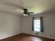 Bedroom with hardwood floors, natural light, ceiling fan, and blue curtains at 2790 Westhampton Way, Tucker, GA 30084