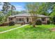 Beautiful brick home with lush front lawn, trimmed shrubs, and complemented by vibrant blooming flowers at 2790 Westhampton Way, Tucker, GA 30084