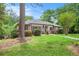 Charming brick home featuring a lush green lawn, mature trees, and colorful landscaping at 2790 Westhampton Way, Tucker, GA 30084
