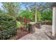 Stone patio with iron railings, brick pillars, and lush plantings at 2790 Westhampton Way, Tucker, GA 30084
