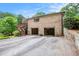 Spacious three-car garage with direct home access and ample parking space, plus stairs to back yard deck at 2790 Westhampton Way, Tucker, GA 30084