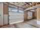 Unfinished garage interior showing door with glass panes and unfinished ceiling at 2790 Westhampton Way, Tucker, GA 30084