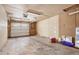 Unfinished garage interior showing shelving, lighting, and bare concrete floor at 2790 Westhampton Way, Tucker, GA 30084