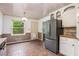 Spacious kitchen area with backyard access, stainless steel refrigerator, and tile flooring at 2790 Westhampton Way, Tucker, GA 30084