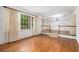 Hardwood flooring, white walls, and large windows create a light and spacious living area at 2790 Westhampton Way, Tucker, GA 30084