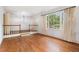 Hardwood flooring, white walls, and large windows create a light and airy living area at 2790 Westhampton Way, Tucker, GA 30084