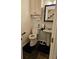 This bathroom features a toilet, sink, mirror, storage cabinet and dark tile floor at 4299 Sherwood Oaks Dr, Decatur, GA 30034