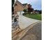 View of the home's exterior highlighting the concrete driveway and landscaping at 4299 Sherwood Oaks Dr, Decatur, GA 30034