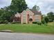 Charming two-story home with a well-manicured lawn and mature trees, showcasing classic suburban appeal at 4299 Sherwood Oaks Dr, Decatur, GA 30034