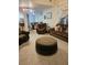 Spacious living room featuring carpeted floors, plush sofas, recliner, and an ottoman at 4299 Sherwood Oaks Dr, Decatur, GA 30034