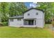 View of a spacious backyard showcasing the home's rear exterior and a screened-in porch at 1728 Hudson Rd, Decatur, GA 30033