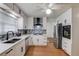 An updated kitchen featuring white cabinets, stainless steel appliances, and hardwood floors at 1728 Hudson Rd, Decatur, GA 30033