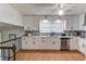 A modern kitchen featuring white cabinets, stainless steel appliances, and a stylish tile backsplash at 1728 Hudson Rd, Decatur, GA 30033