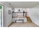 Open-concept living room showing stairs and kitchen featuring light-filled, split-level living at 1728 Hudson Rd, Decatur, GA 30033