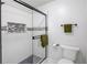 A shower stall with black trim, hexagon tile floor and decorative mosaic tile insert at 1728 Hudson Rd, Decatur, GA 30033