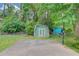 Backyard features a storage building on a concrete pad with a basketball hoop at 1728 Hudson Rd, Decatur, GA 30033