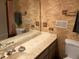A cozy bathroom features patterned wallpaper, vanity with marble top and large mirror at 3215 Hembry Ct, Marietta, GA 30062