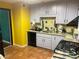 Kitchen featuring tile floor, tile backsplash, stainless steel sink and black dishwasher at 3215 Hembry Ct, Marietta, GA 30062