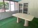 Enclosed sunroom featuring a table, green carpet, vinyl windows and siding, and access to the backyard at 3215 Hembry Ct, Marietta, GA 30062