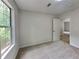 This is a cozy bedroom with a plush carpet and natural light from a large window at 829 Longfellow Ct, Stone Mountain, GA 30088