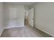 Carpeted bedroom featuring a closet and doorway leading to a bathroom at 829 Longfellow Ct, Stone Mountain, GA 30088