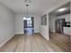 Open dining area featuring wood flooring, a modern chandelier, and natural light from the window overlooking the backyard at 829 Longfellow Ct, Stone Mountain, GA 30088