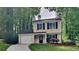 Charming two-story home with a well-maintained lawn and a paved driveway leading to a single-car garage at 829 Longfellow Ct, Stone Mountain, GA 30088